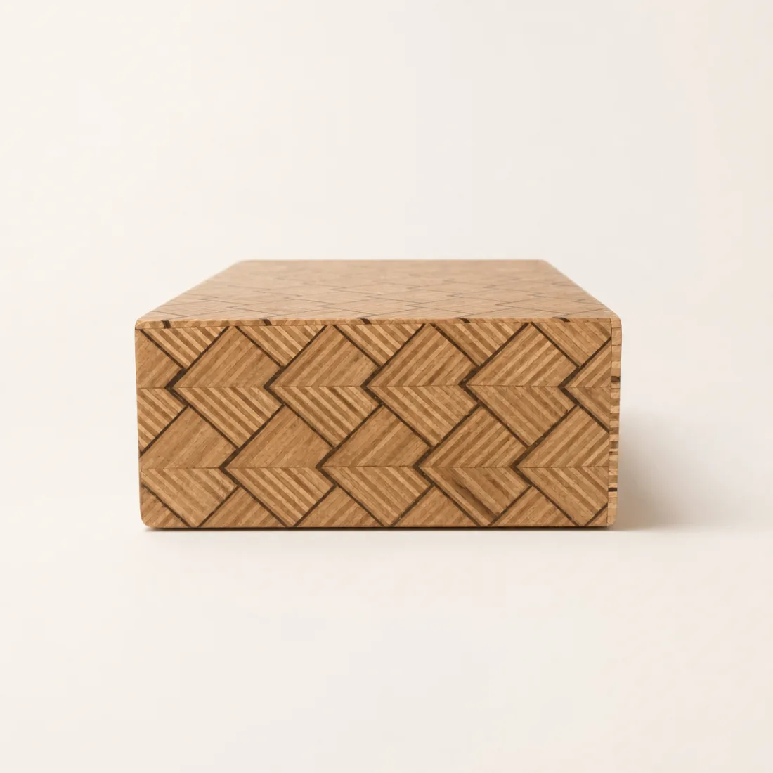 Side view of the large stepped-chevron pattern wrapping the wooden drawer box