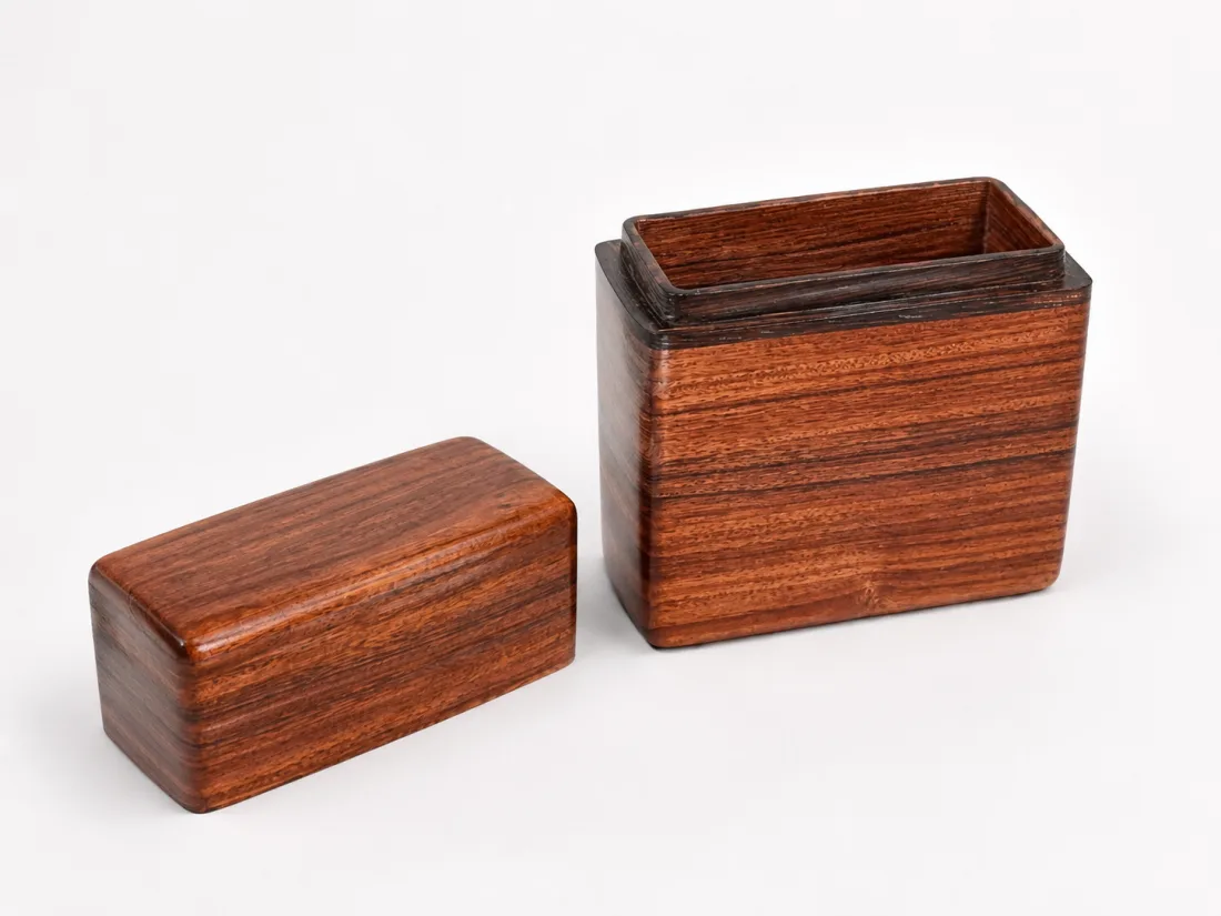 Detail of the reddish card box and its fitted lift-off lid