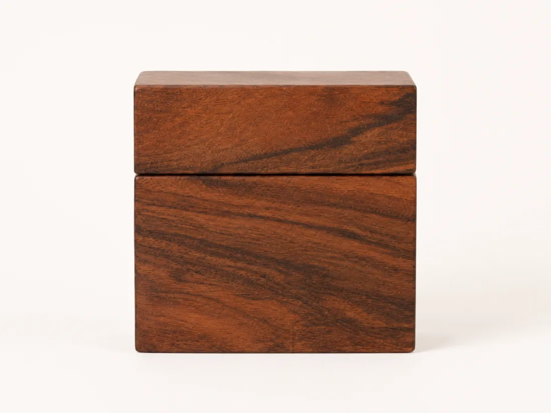 The reddish card box open, its lift-off lid set alongside