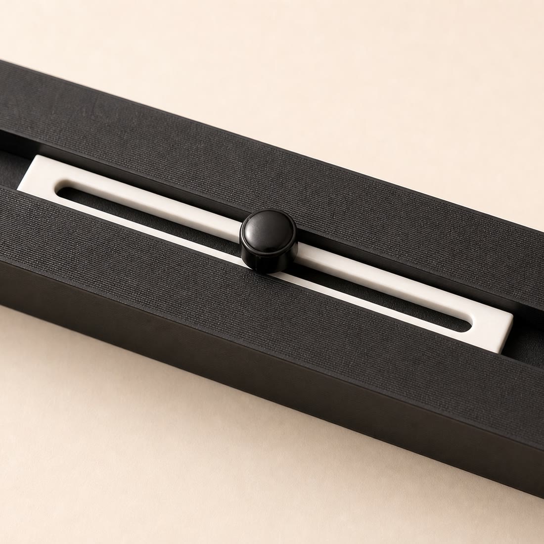 Close-up of the sliding stop and locking knob in the strip channel